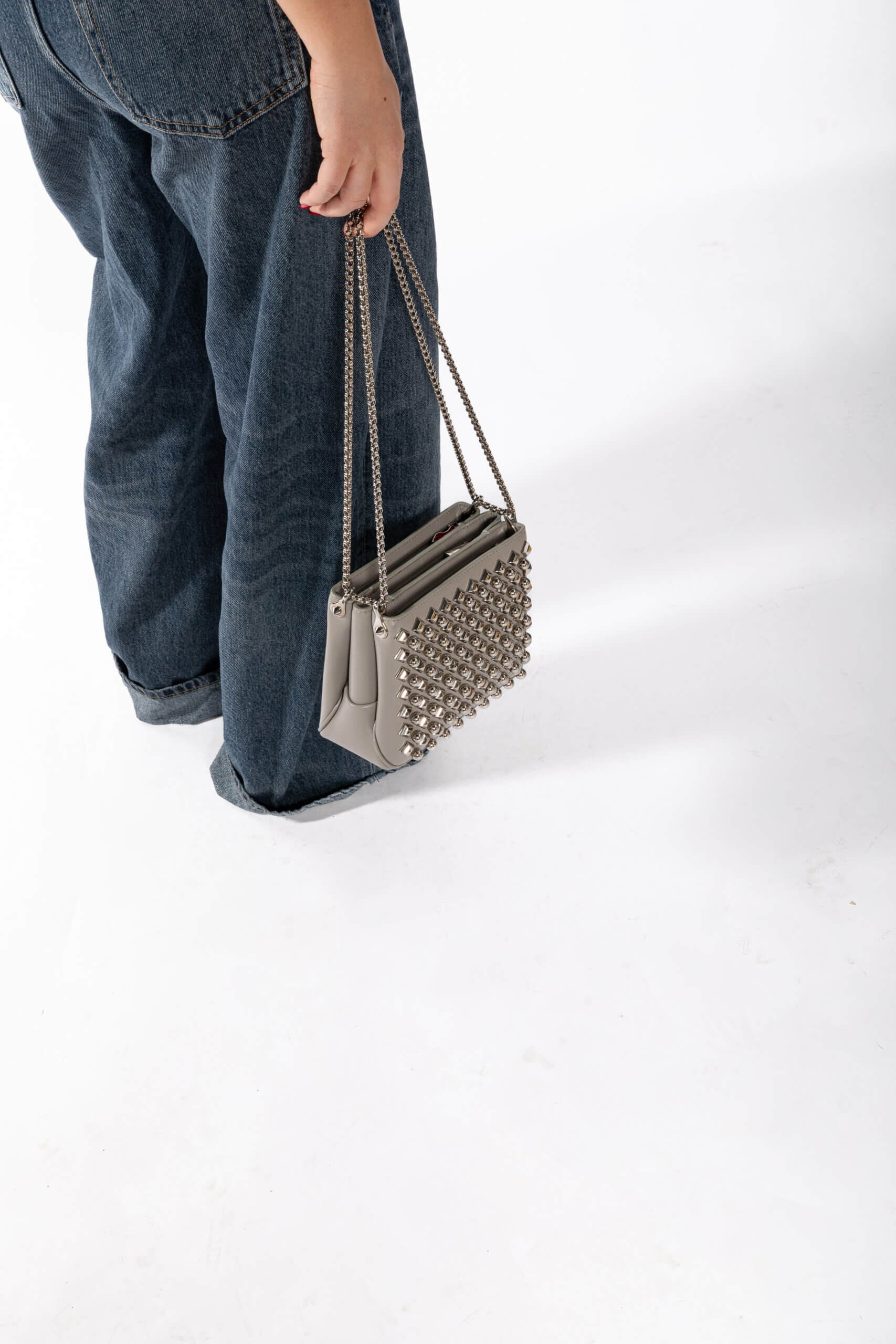 <span style="font-size: 10px; color: rgb(101, 101, 101);letter-spacing: .15em;">BEST DEAL</span><br><strong> CHRISTIAN LOUBOUTIN </strong><br><div style="margin-top:10px; font-size:16px;"> Silver Leather Studded Triloubi Clutch Bag </div><br> - Image 4