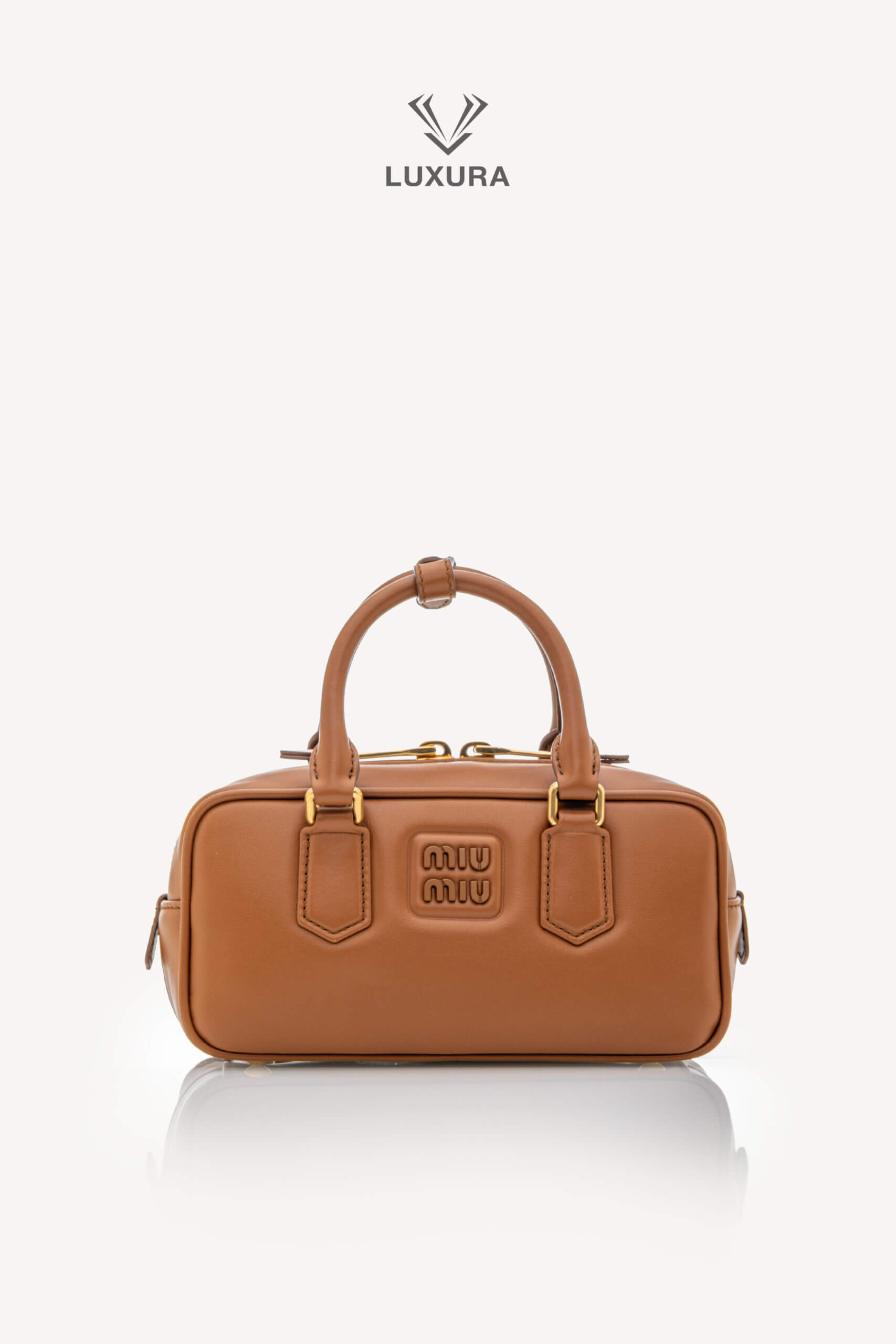 <span style="font-size: 10px;letter-spacing: .15em">IN TRENDING</span><br>            <strong>MIU MIU</strong><br>            <div style="margin-top:10px;font-size:16px">Calfskin Small Arcadie Top Handle Cognac</div><br> - Image 4