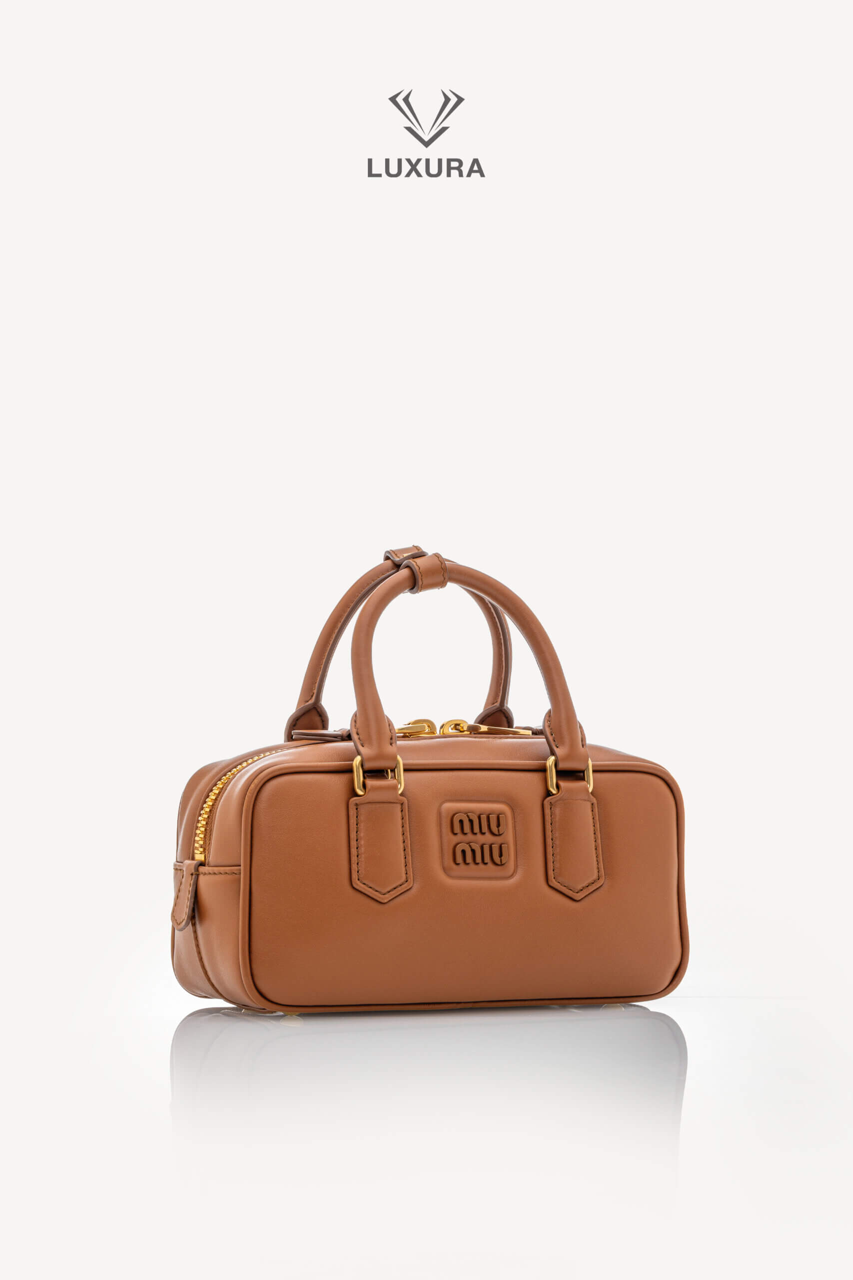 <span style="font-size: 10px;letter-spacing: .15em">IN TRENDING</span><br>            <strong>MIU MIU</strong><br>            <div style="margin-top:10px;font-size:16px">Calfskin Small Arcadie Top Handle Cognac</div><br> - Image 3
