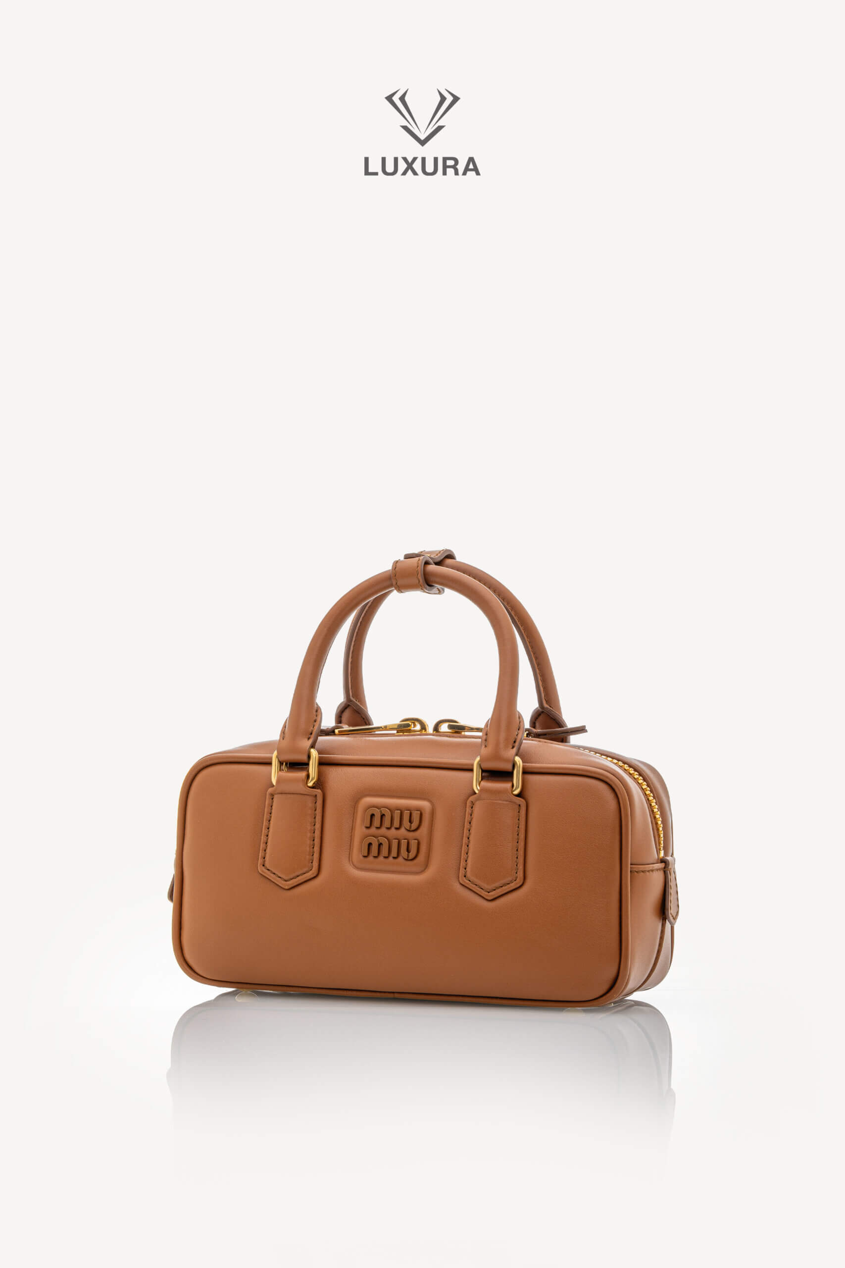 <span style="font-size: 10px;letter-spacing: .15em">IN TRENDING</span><br>            <strong>MIU MIU</strong><br>            <div style="margin-top:10px;font-size:16px">Calfskin Small Arcadie Top Handle Cognac</div><br> - Image 7