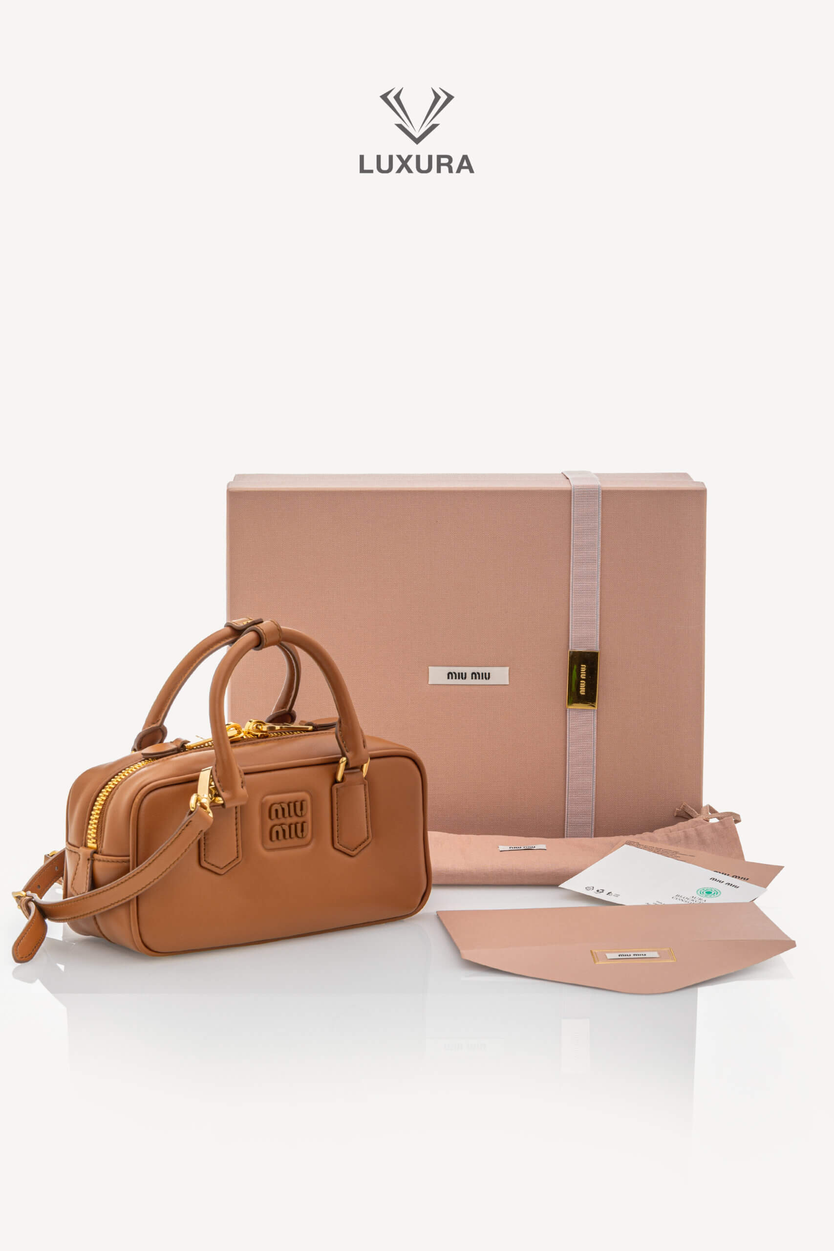 <span style="font-size: 10px;letter-spacing: .15em">IN TRENDING</span><br>            <strong>MIU MIU</strong><br>            <div style="margin-top:10px;font-size:16px">Calfskin Small Arcadie Top Handle Cognac</div><br> - Image 2