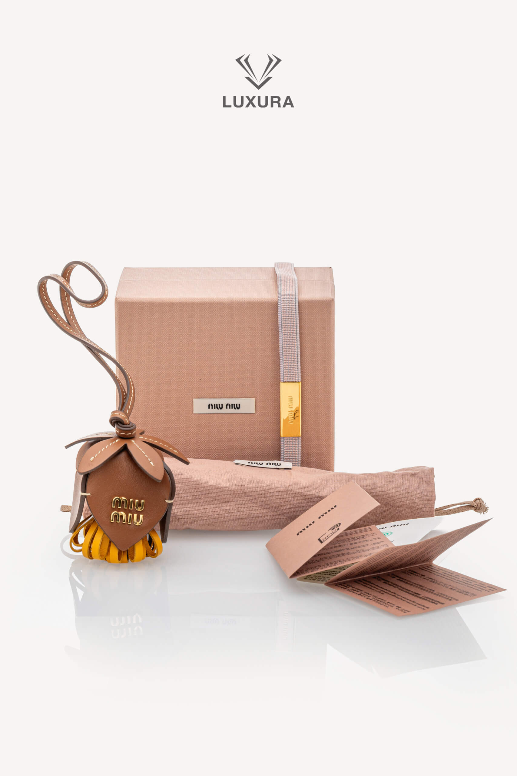 <span style="font-size: 10px;letter-spacing: .15em">HARD TO FIND</span><br>            <strong>MIU MIU</strong><br>            <div style="margin-top:10px;font-size:16px">Calfskin Trick Bag Charm Brown-Mustard Yellow</div><br> - Image 2