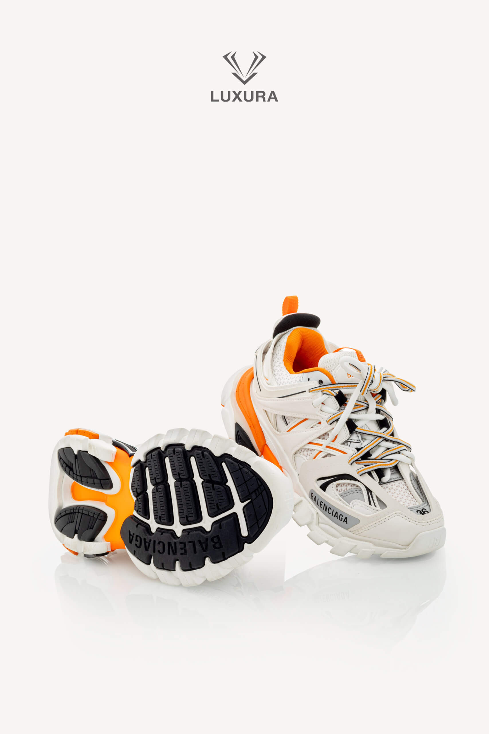<span style="font-size: 10px;letter-spacing: .15em">IN TRENDING</span><br>            <strong>BALENCIAGA</strong><br>            <div style="margin-top:10px;font-size:16px">Track Sneakers in White and Orange Mesh and Nylon 36 [EXT]</div><br> - Image 26