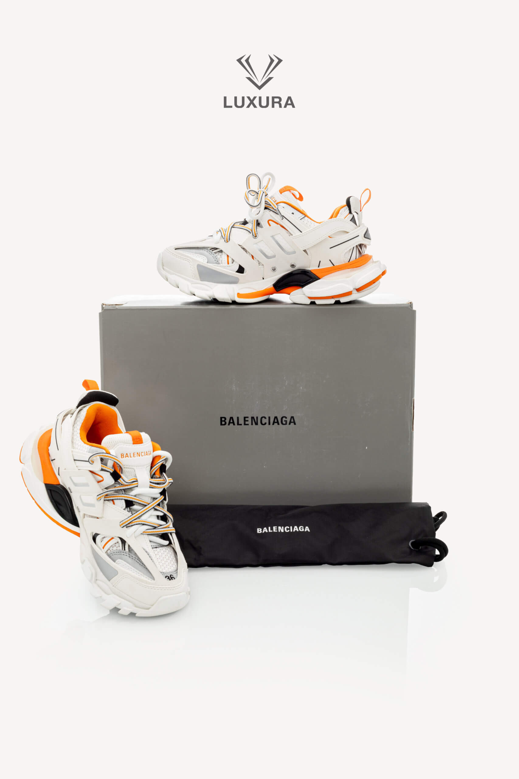 <span style="font-size: 10px;letter-spacing: .15em">IN TRENDING</span><br>            <strong>BALENCIAGA</strong><br>            <div style="margin-top:10px;font-size:16px">Track Sneakers in White and Orange Mesh and Nylon 36 [EXT]</div><br> - Image 2