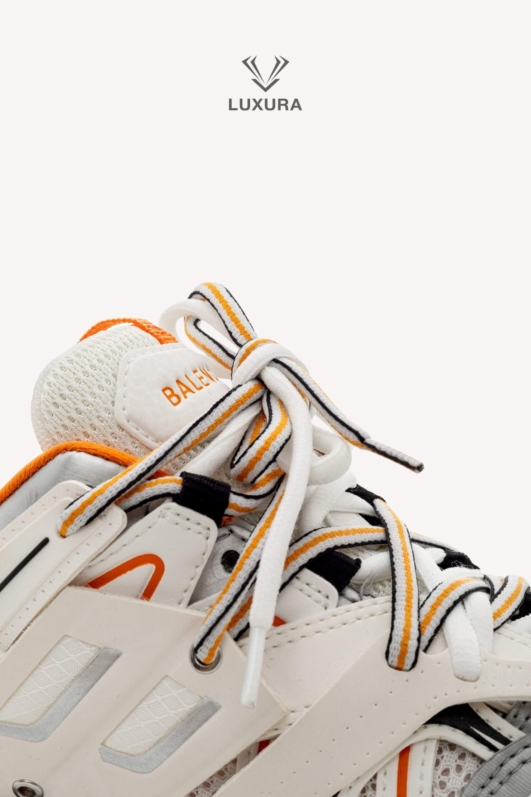 <span style="font-size: 10px;letter-spacing: .15em">IN TRENDING</span><br>            <strong>BALENCIAGA</strong><br>            <div style="margin-top:10px;font-size:16px">Track Sneakers in White and Orange Mesh and Nylon 36 [EXT]</div><br> - Image 16