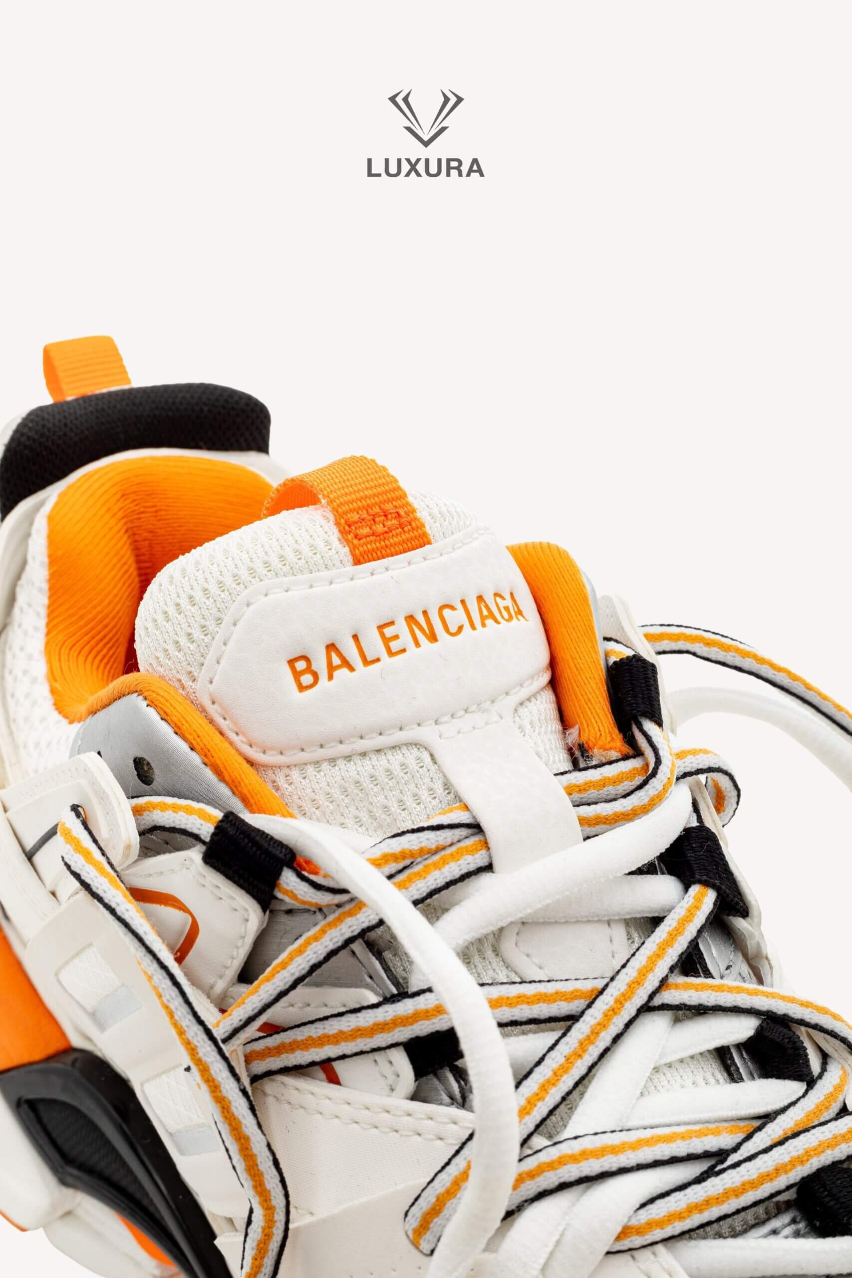 <span style="font-size: 10px;letter-spacing: .15em">IN TRENDING</span><br>            <strong>BALENCIAGA</strong><br>            <div style="margin-top:10px;font-size:16px">Track Sneakers in White and Orange Mesh and Nylon 36 [EXT]</div><br> - Image 17