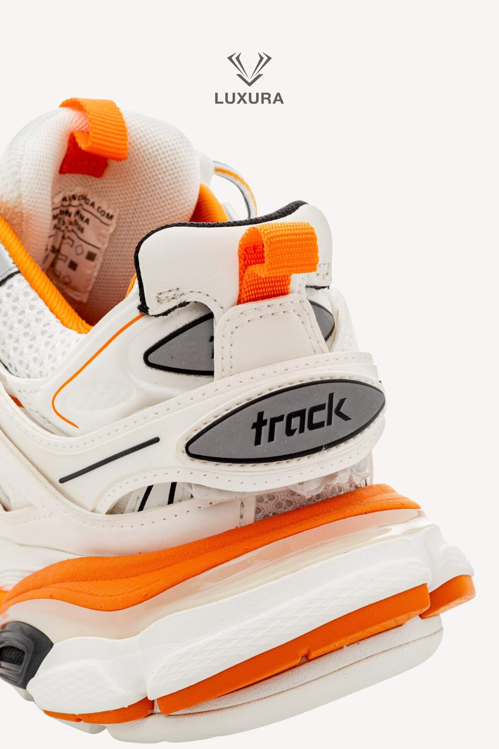 <span style="font-size: 10px;letter-spacing: .15em">IN TRENDING</span><br>            <strong>BALENCIAGA</strong><br>            <div style="margin-top:10px;font-size:16px">Track Sneakers in White and Orange Mesh and Nylon 36 [EXT]</div><br> - Image 19