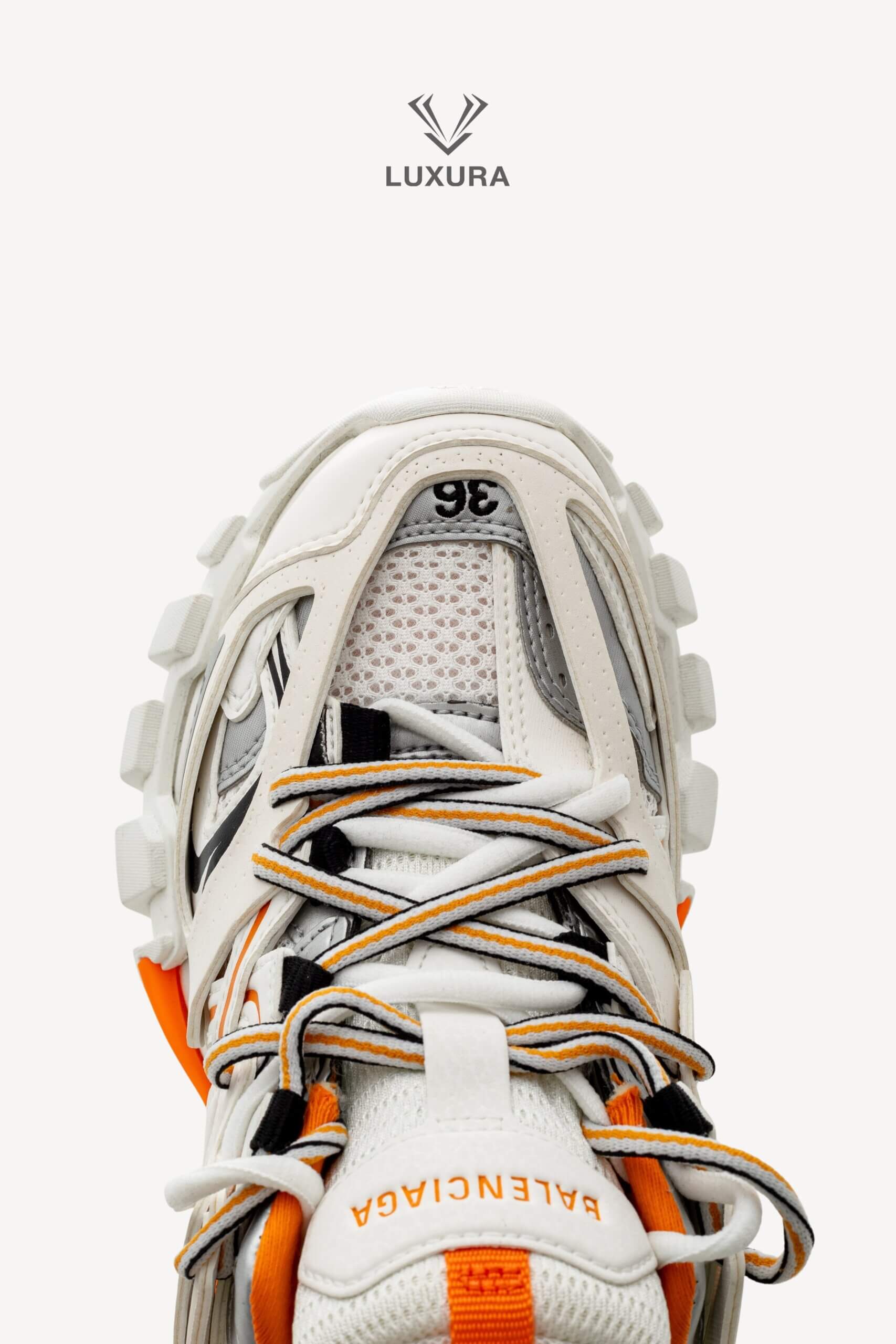 <span style="font-size: 10px;letter-spacing: .15em">IN TRENDING</span><br>            <strong>BALENCIAGA</strong><br>            <div style="margin-top:10px;font-size:16px">Track Sneakers in White and Orange Mesh and Nylon 36 [EXT]</div><br> - Image 13
