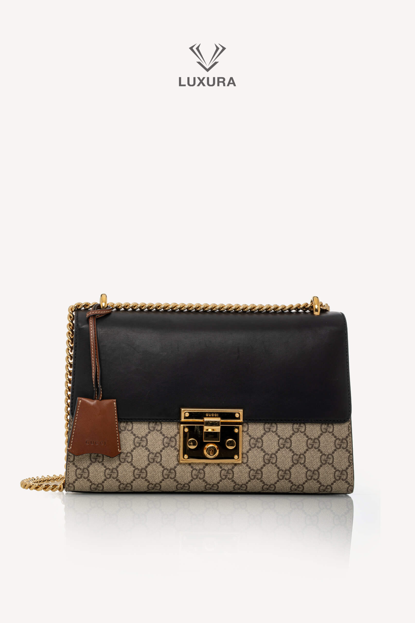 <span style="font-size: 10px;letter-spacing: .15em">IN TRENDING</span><br> <strong>GUCCI</strong><br> <div style="margin-top:10px;font-size:16px">Supreme Monogram Calfskin Medium Padlock Shoulder Bag Brown Black</div><br>